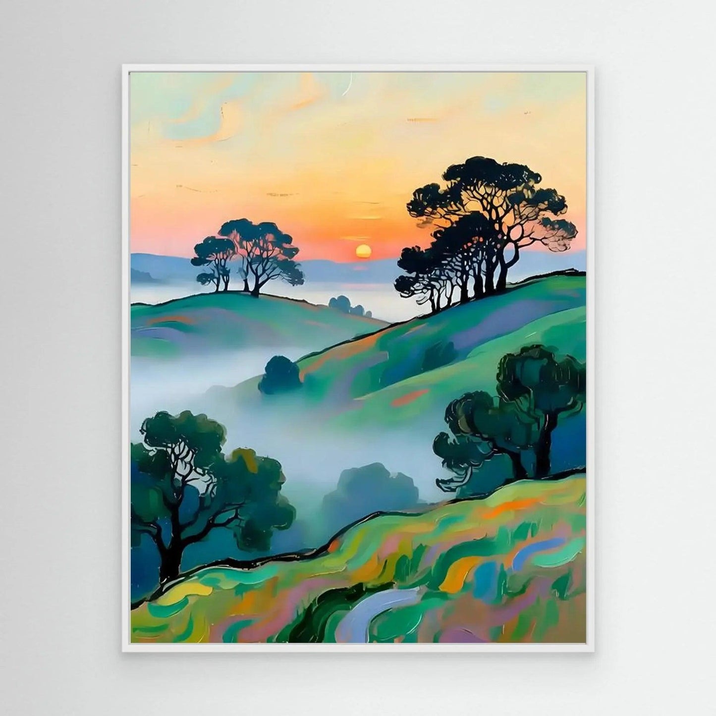 Framed wall art featuring a sunset landscape with rolling hills, trees, and haze