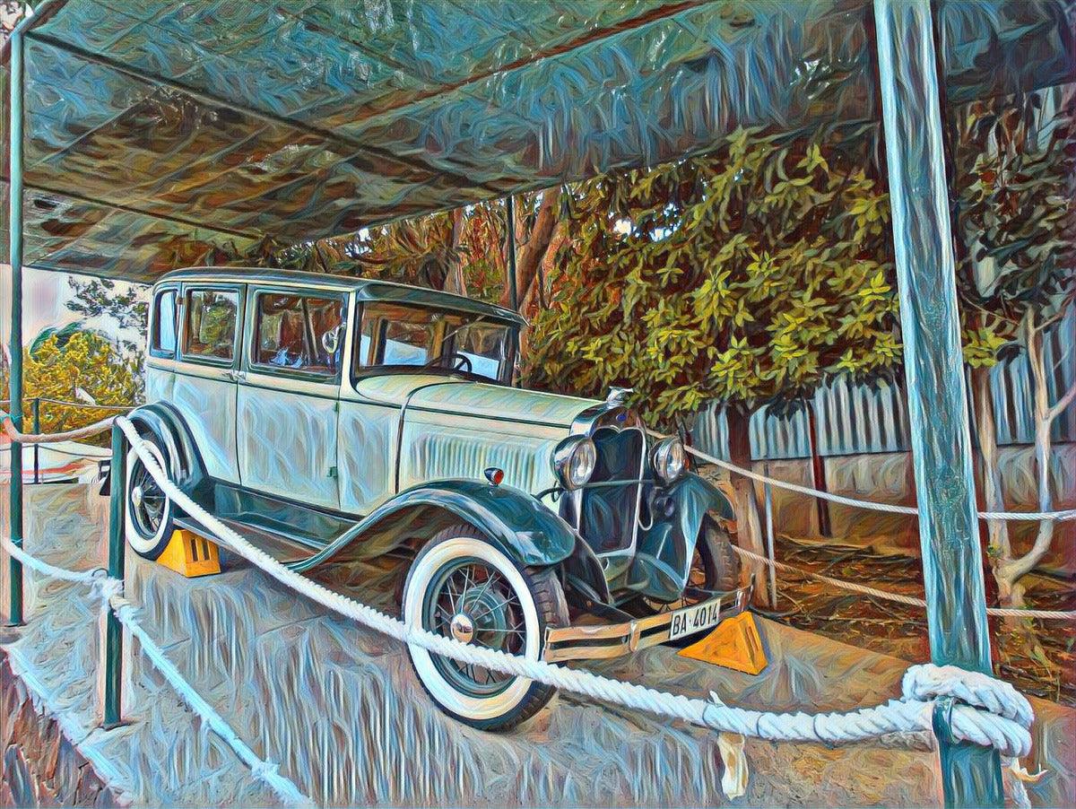 Close-up of vintage blue car artwork with rope canopy and roadside trees