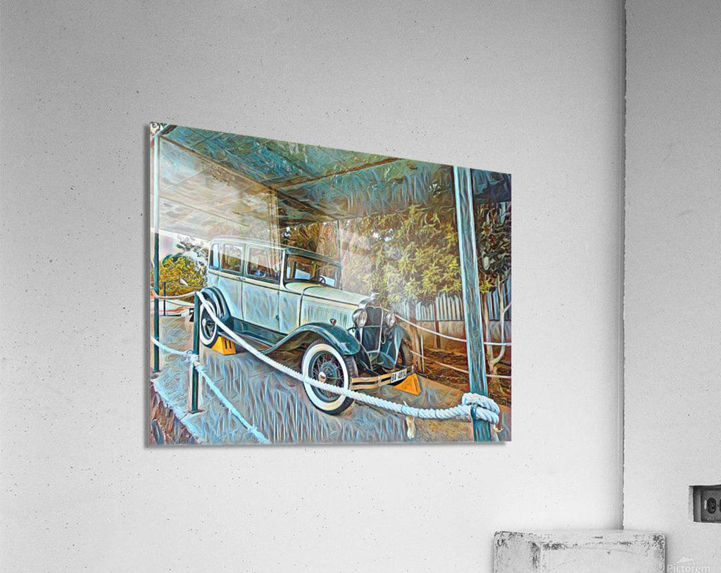 Close view of framed vintage blue car wall art on a light wall