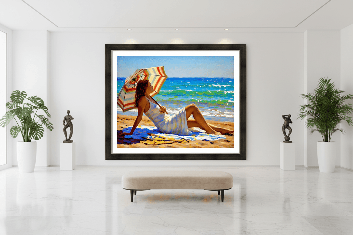 Framed beach artwork featuring a reclining woman holding a striped umbrella