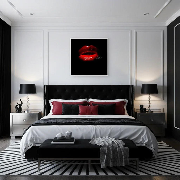 Framed wall art of glossy red lips on black background, white frame