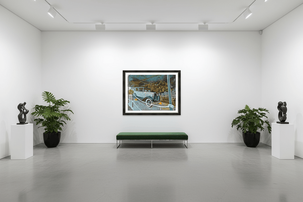 Framed vintage car artwork in a gallery room with bench and potted plants