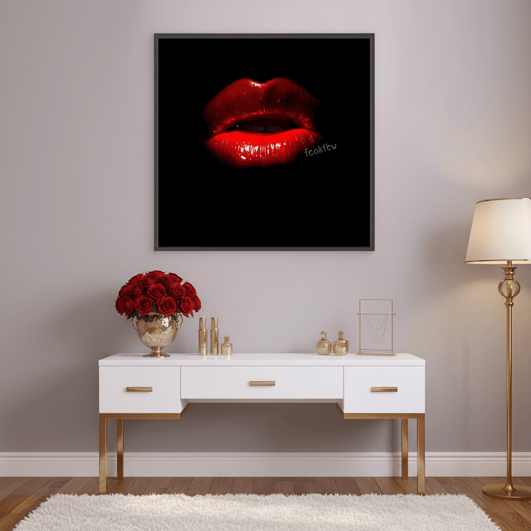 Framed wall art of glossy red lips on black background, black frame