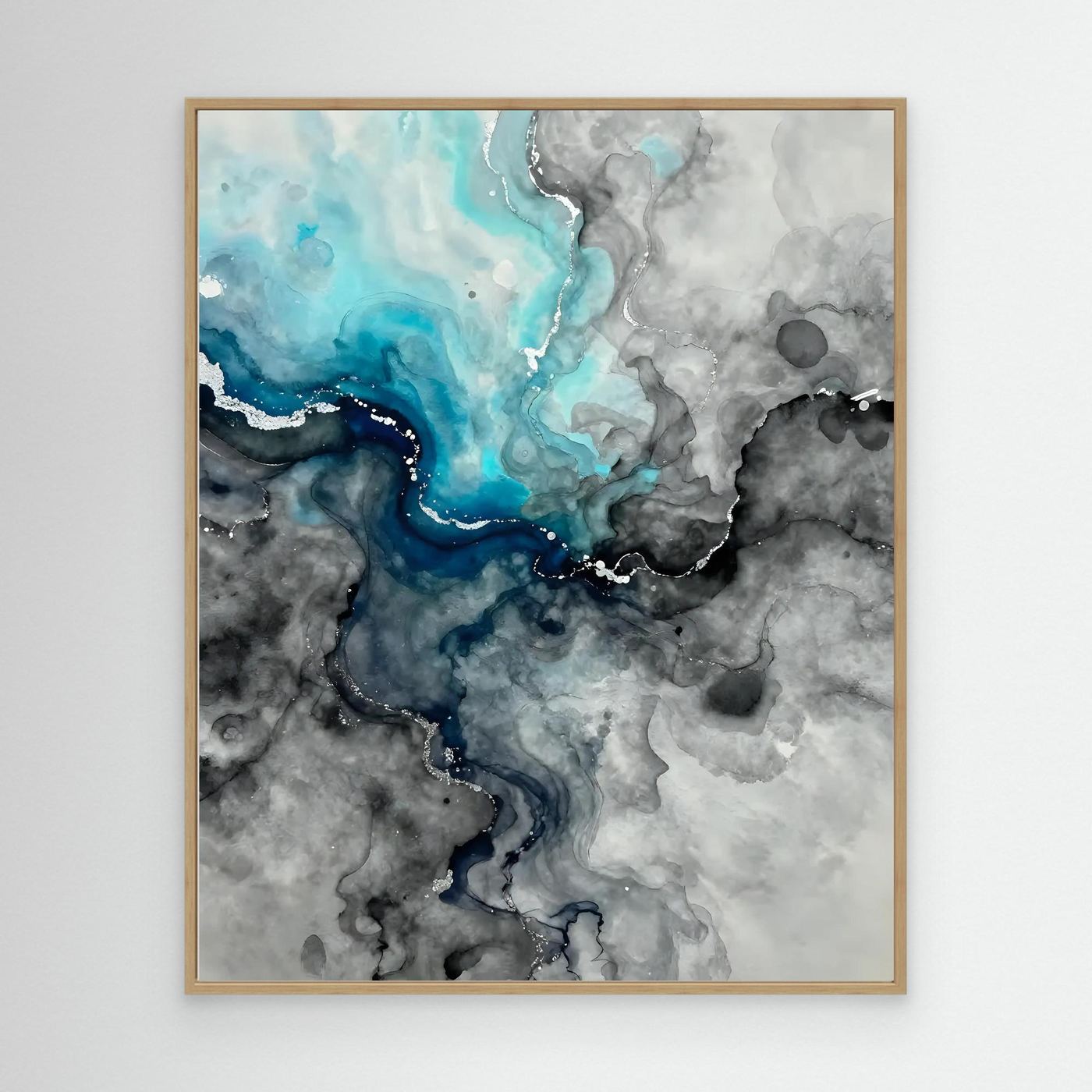 Framed abstract wall art with blue and gray marbling, light wood frame.