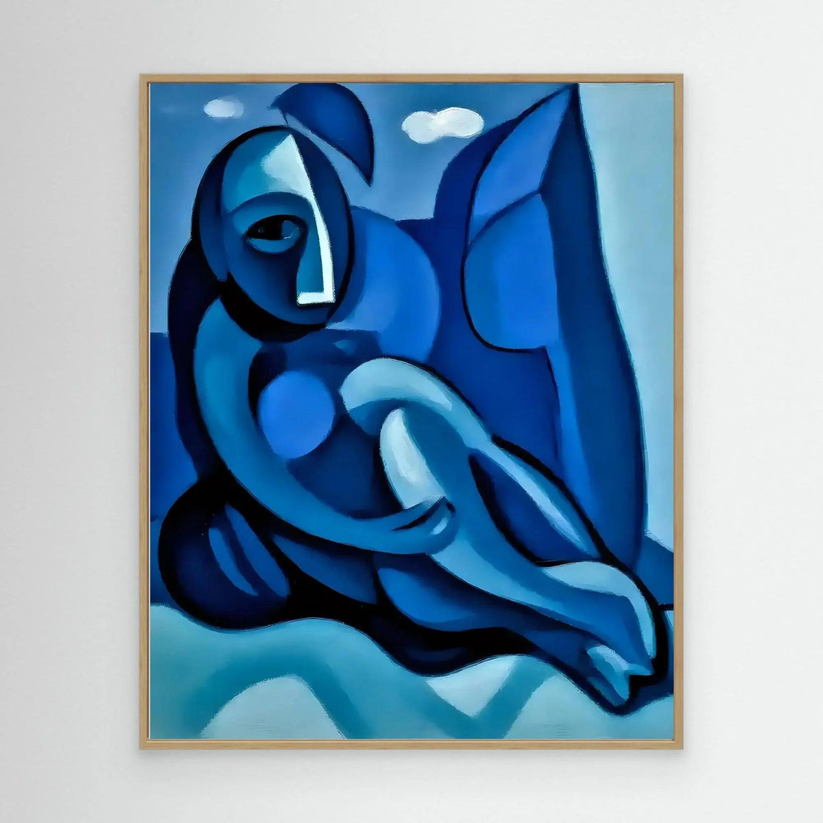 Abstract blue figure painting with a gold-tone frame, reclining body in layered blue shades.