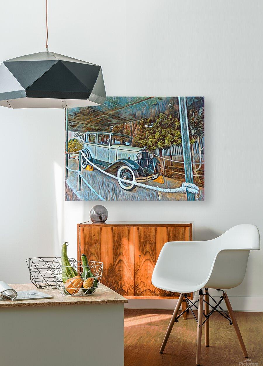 Framed vintage car wall art above a wooden console with chair and lamp