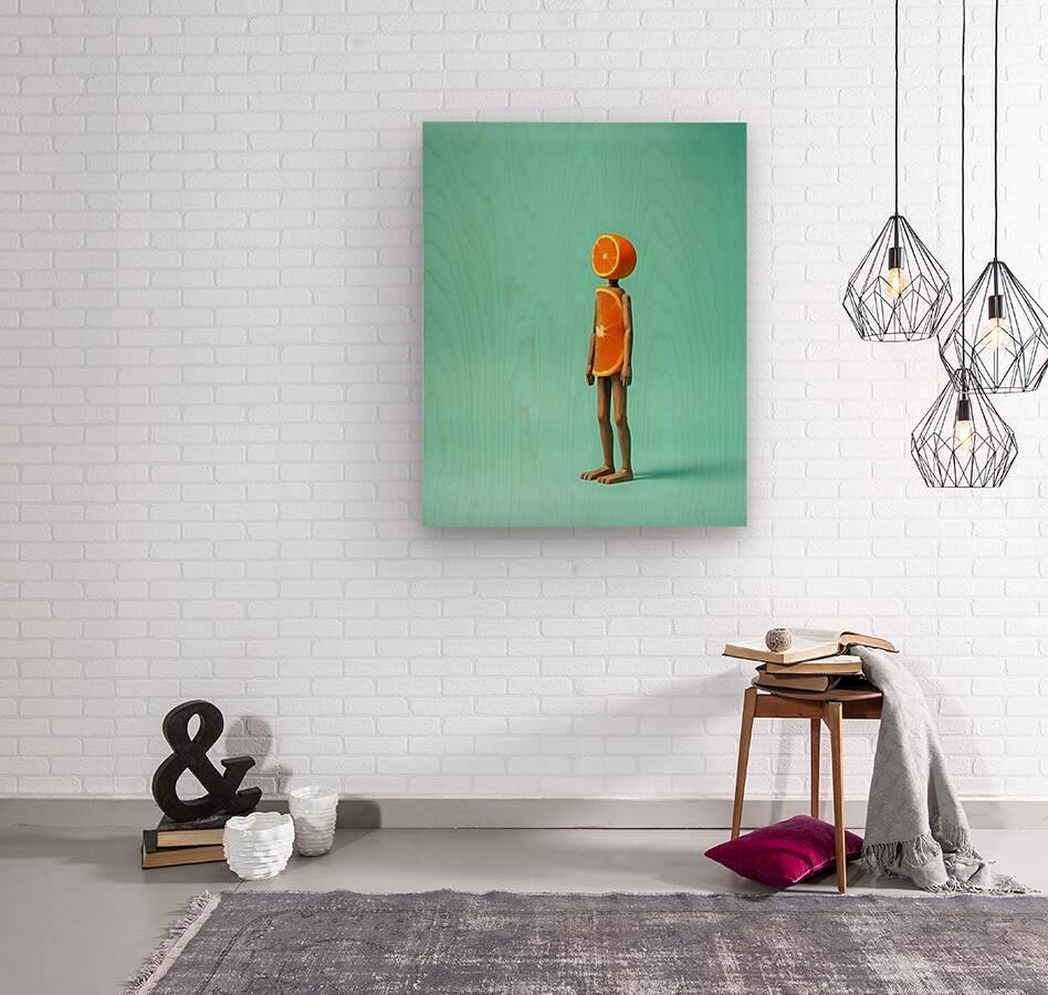 Framed abstract wall art with orange fruit-headed figure on teal background