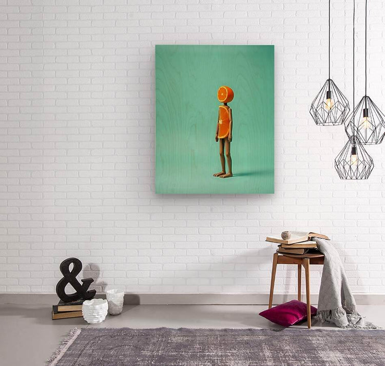 Framed abstract wall art with orange fruit-headed figure on teal background
