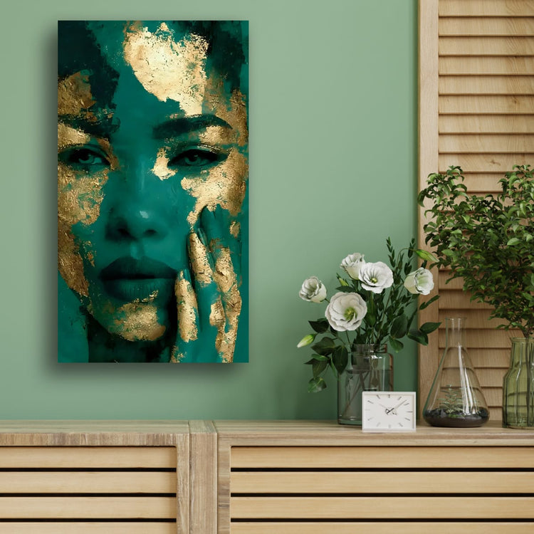Teal and gold textured portrait wall art of a face, set against green wall.